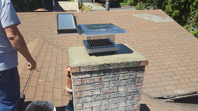 A new crown of sand and cement is poured on top of a chimney. A new stainless steel rain cap is installed.