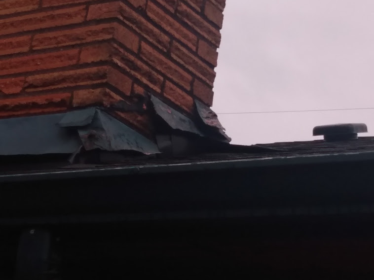 Bent chimney step flashing.